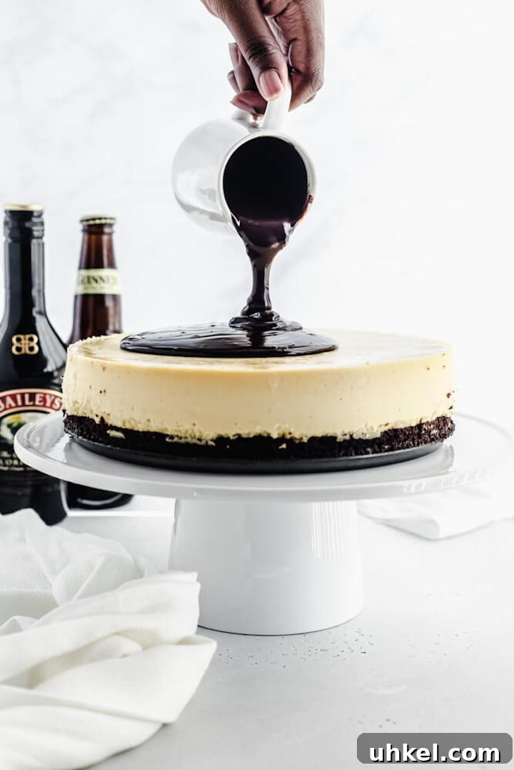 Baileys Brownie Cheesecake Recipe: Decadent Chocolate Whiskey Cheesecake 8 pouring ganache onto cheesecake