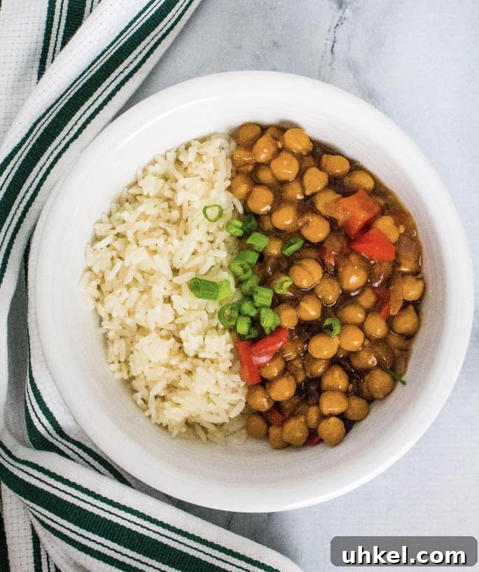 white bowl filled with white rice and kung pao chickpeas made in the Instant Pot