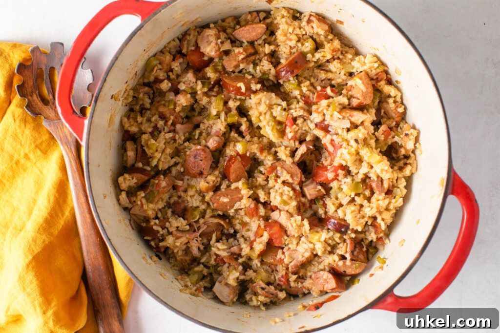 Authentic Chicken Jambalaya: Step-by-Step Homemade Recipe 3 pot of easy chicken jambalaya with a wooden spoon