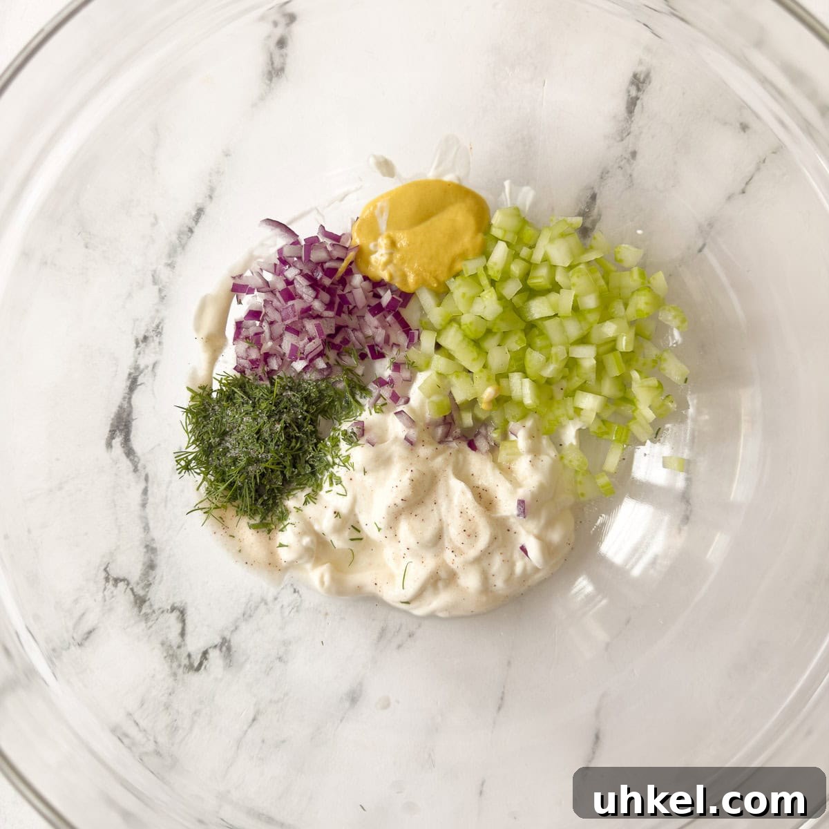 Tuna and Chickpea Salad with Lemon-Dill Dressing 4 Chickpea tuna salad ingredients in a glass bowl to be mixed.
