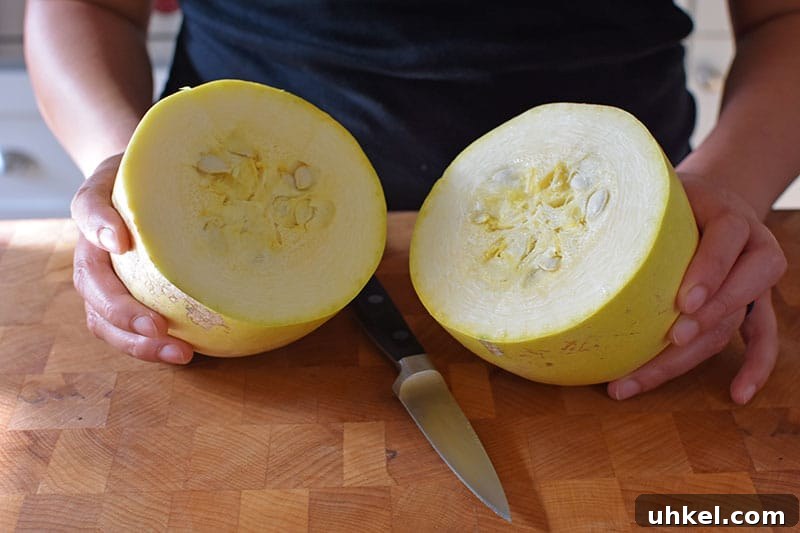 Instant Pot Spaghetti Squash — Quick Foolproof Pressure Cooker Recipe 7 A spaghetti squash is cut in half horizontally with a small paring knife.