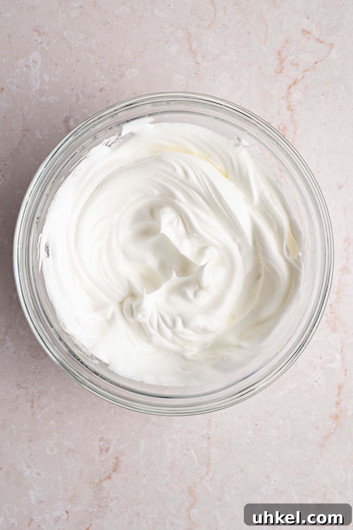 The beaten egg whites in a large bowl.