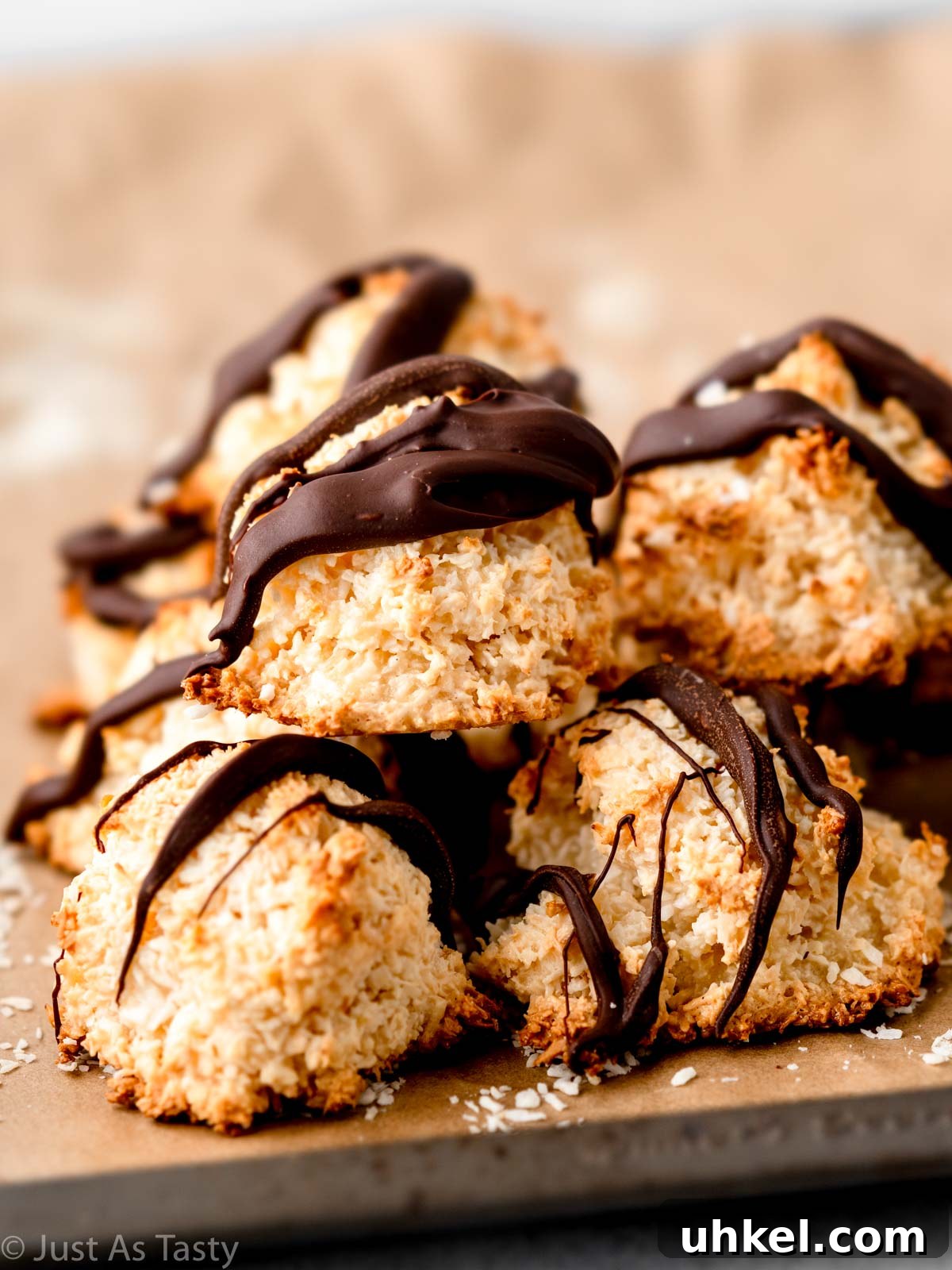Chewy Chocolate Coconut Macaroons Made with Condensed Milk 2 Stack of coconut macaroons drizzled with chocolate.