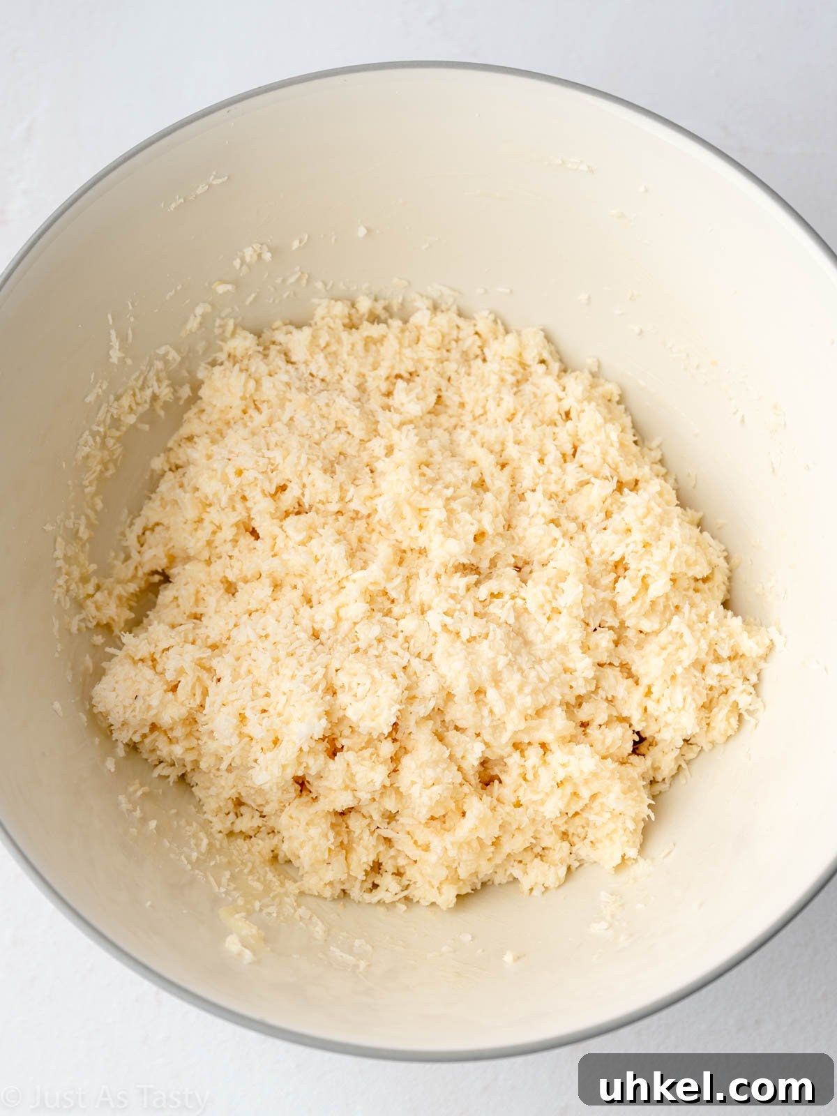Chewy Chocolate Coconut Macaroons Made with Condensed Milk 4 Coconut macaroon mixture in a bowl.