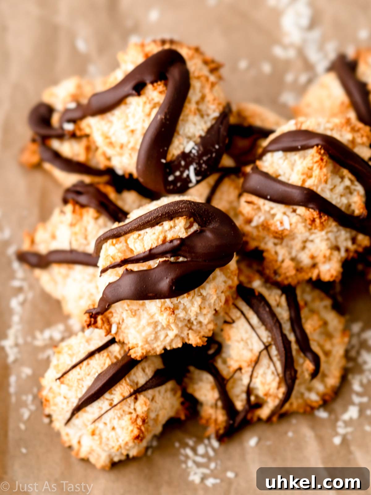 Chewy Chocolate Coconut Macaroons Made with Condensed Milk 6 Pile of chocolate coconut macaroons on parchment paper.