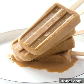 Boozy Caramel Coffee Popsicles Recipe for Adults 2 Boozy caramel coffee popsicles on a white plate.