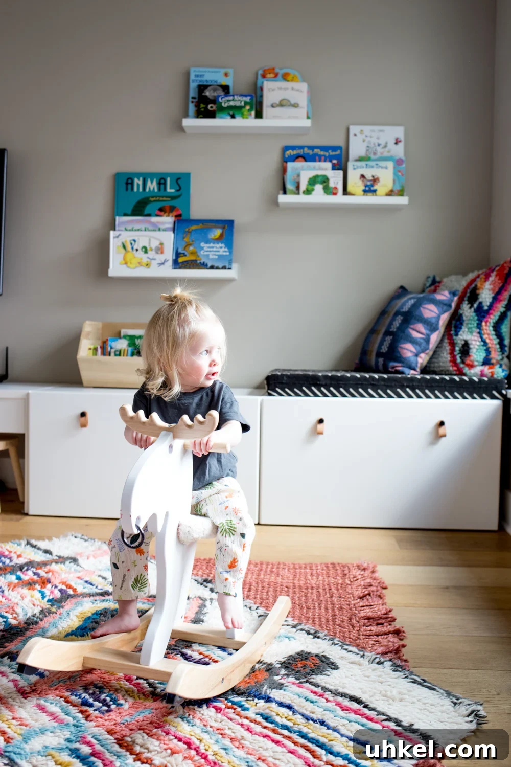 Declutter Kids' Toys: Simple Steps to Tidy Playrooms 4 cute toddler girl on rocking moose in play room