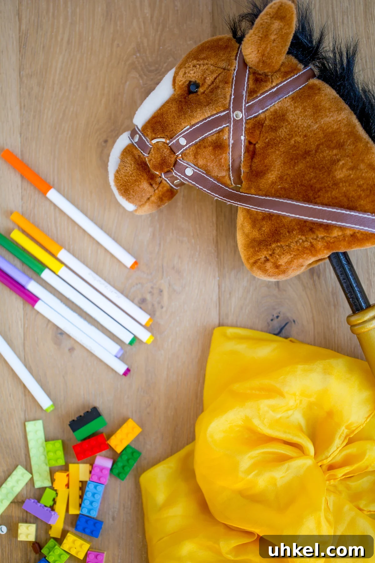 Declutter Kids' Toys: Simple Steps to Tidy Playrooms 5 open ended toys like classic legos, play silk scarf, markers and horse on a stick
