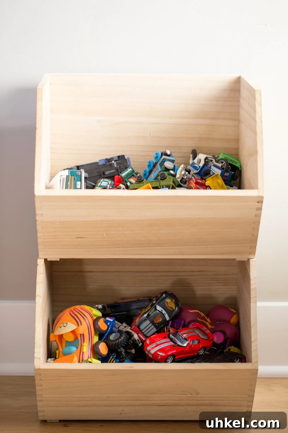 Declutter Kids' Toys: Simple Steps to Tidy Playrooms 8 stacked wooden toy storage boxes with toy cars inside