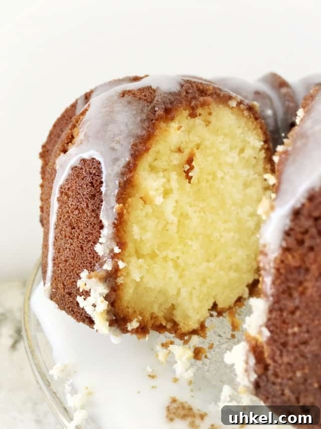 How to Make Glossy Cake Glaze for Shiny, Smooth Cakes 2 A view into the cut pound cake with glaze dripping down the side