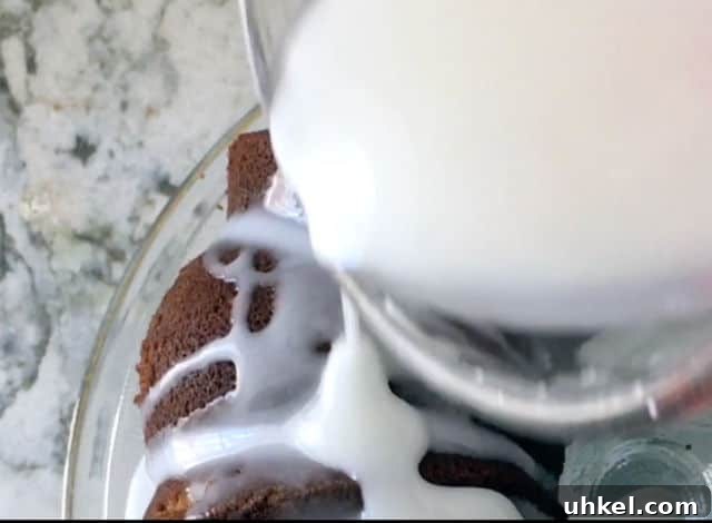 How to Make Glossy Cake Glaze for Shiny, Smooth Cakes 4 liquid measuring cup pouring cake glaze over the top of the cake
