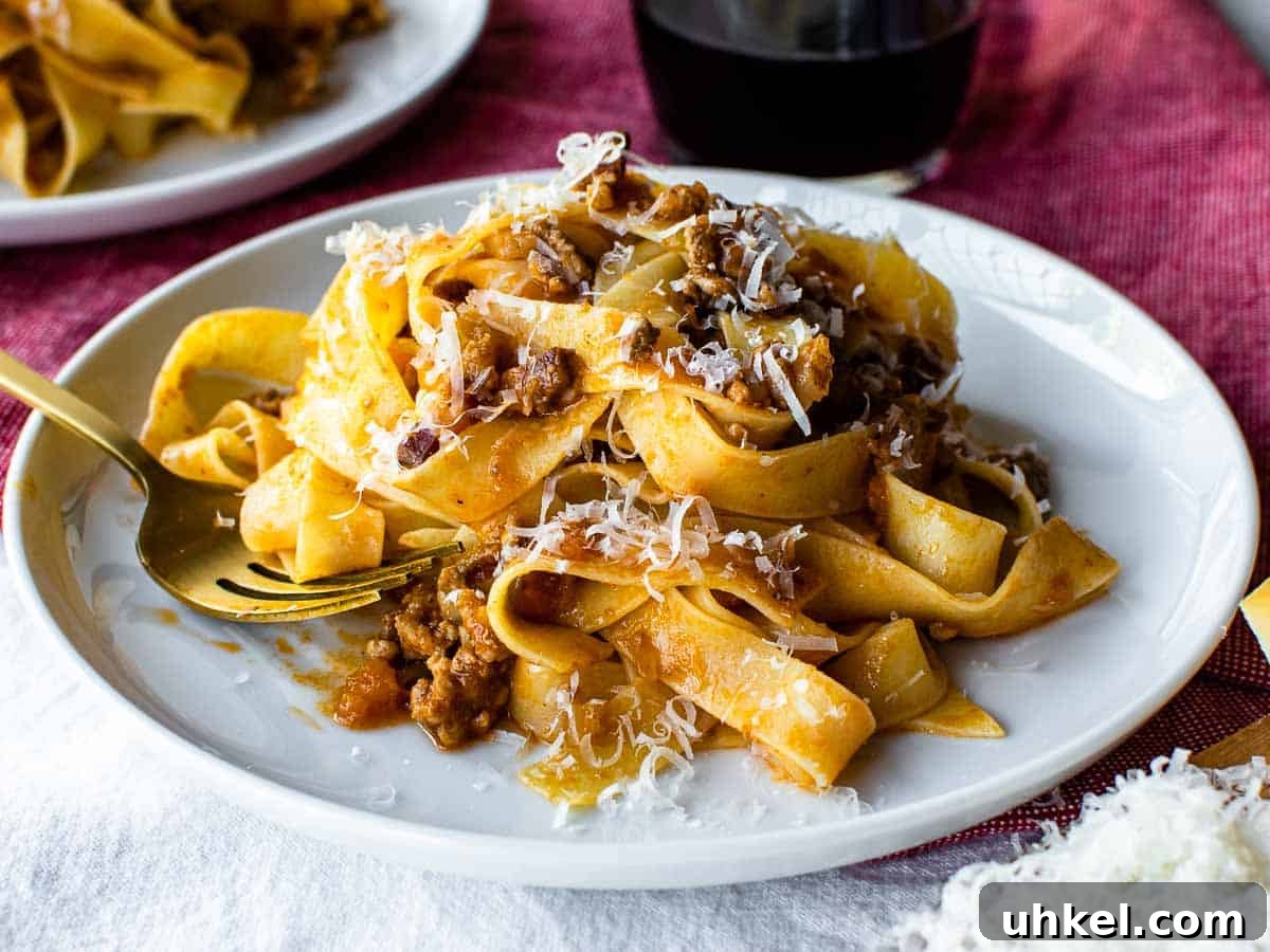 Authentic Tagliatelle alla Bolognese Recipe 11 Close up of white plate with pasta on.