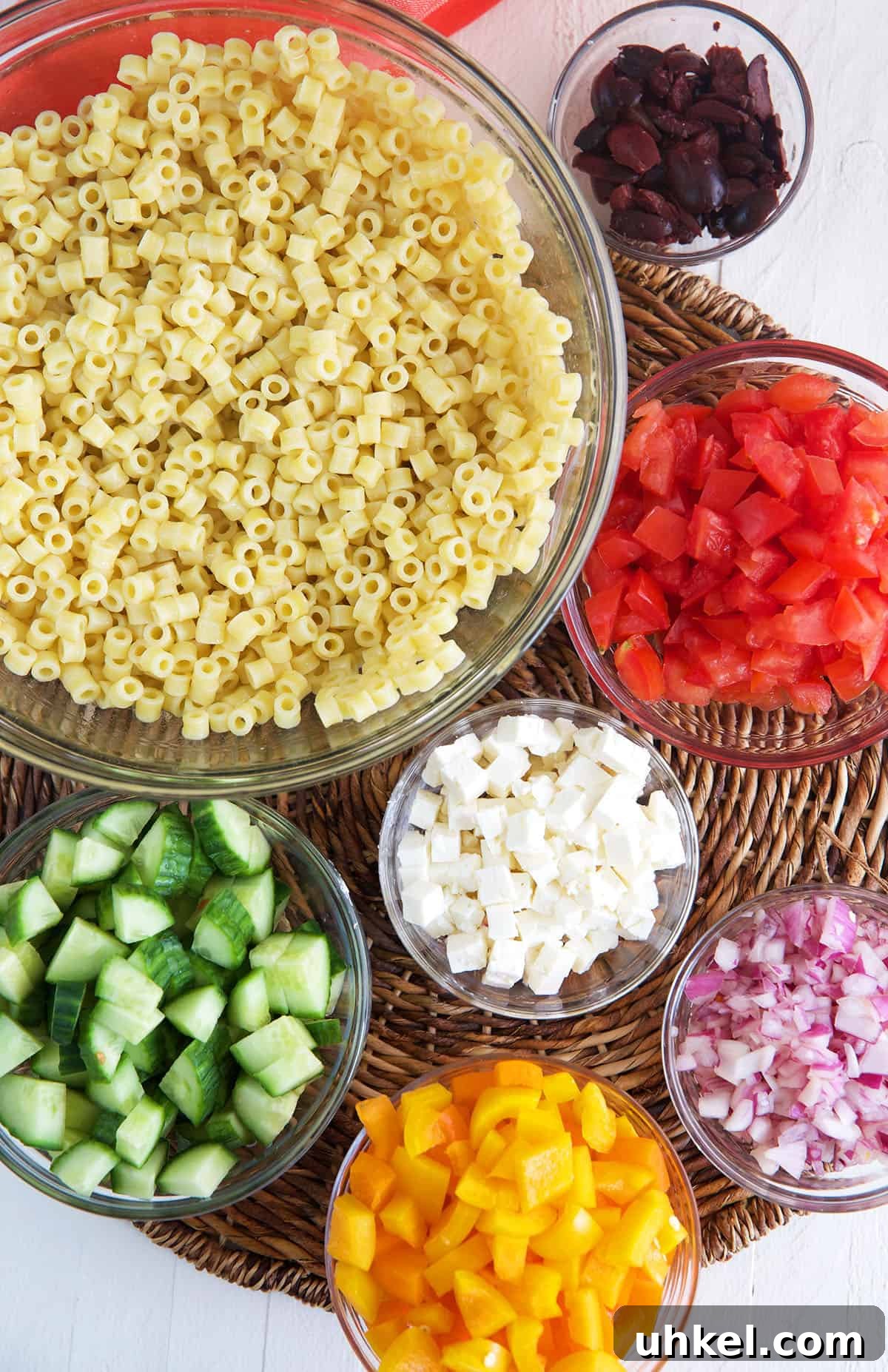 Greek Pasta Salad with Feta, Olives & Fresh Tomatoes 3 Ingredients for Greek Pasta Salad in glass bowls.