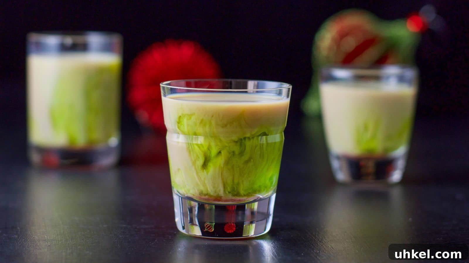 Mangled Frog Shot: 12 Christmas Shot Recipes 3 three glasses with a green and beige liqueur layered in it