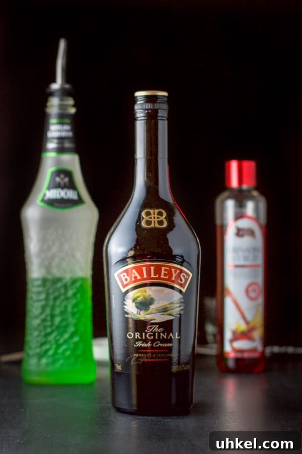 Mangled Frog Shot: 12 Christmas Shot Recipes 4 Baileys Midori and grenadine on a black board