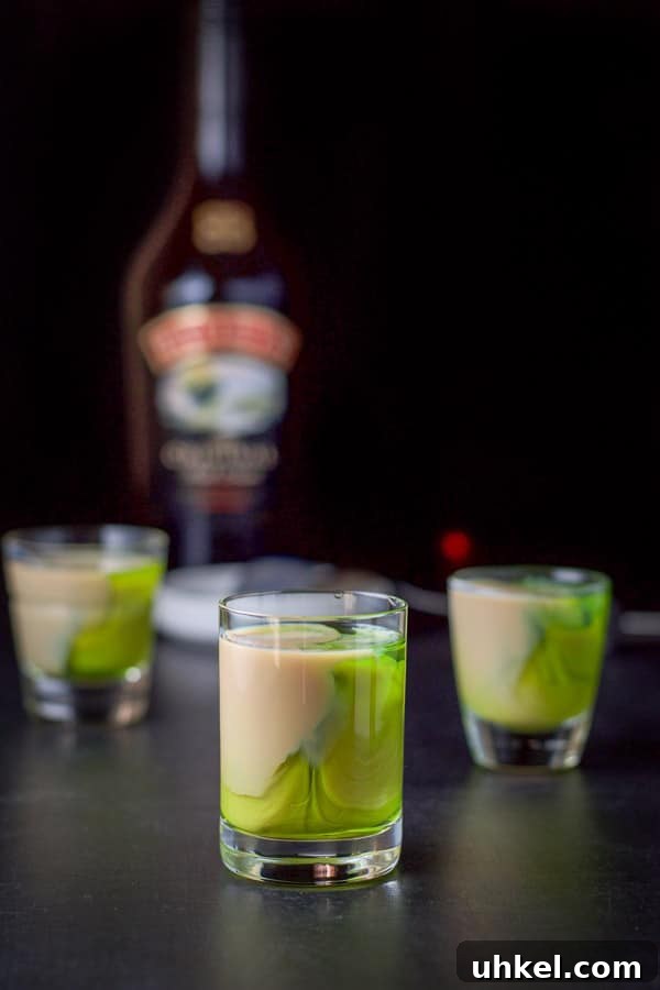 Mangled Frog Shot: 12 Christmas Shot Recipes 6 Baileys layered into the glasses with the bottle in the background