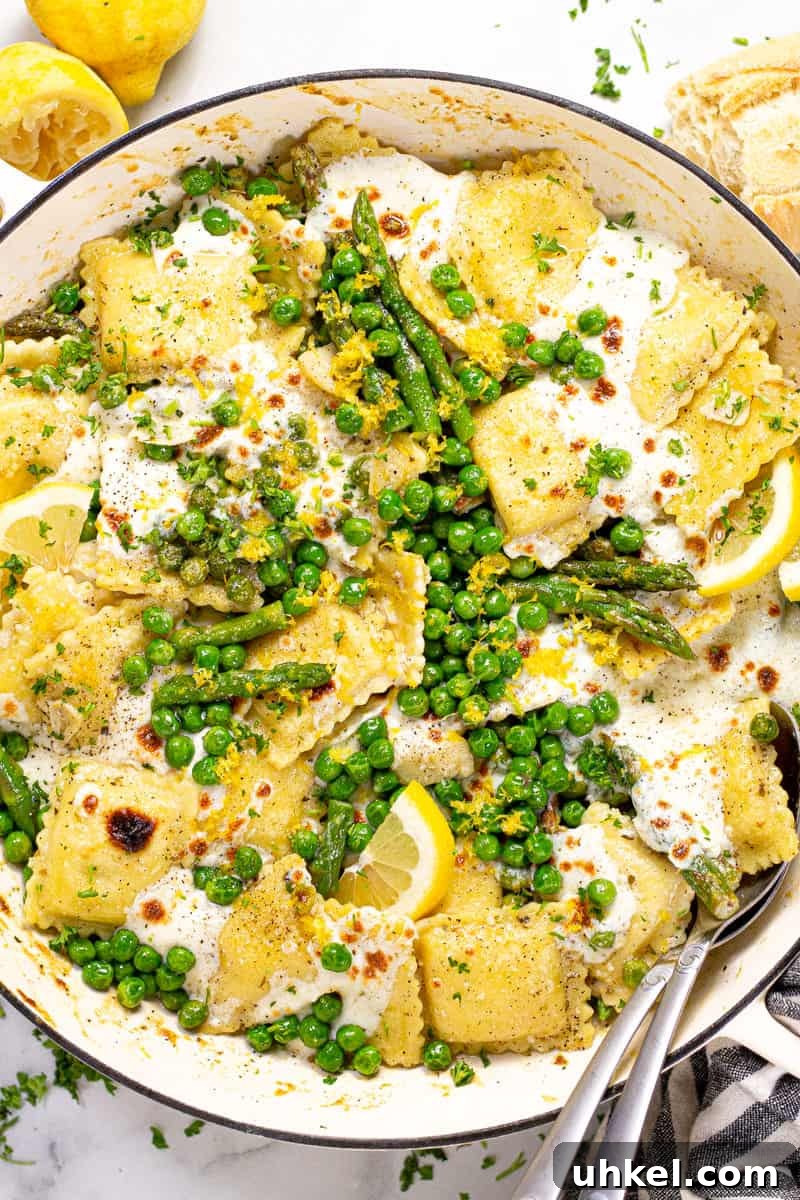 Spring Ravioli with Peas and Asparagus 2 Overhead shot of a large white pan filled with spring ravioli with asparagus peas and cheese