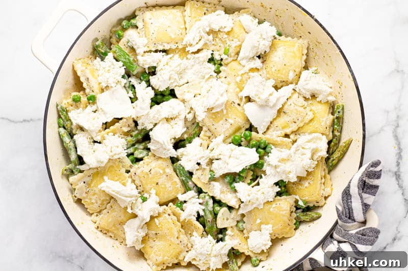 Spring Ravioli with Peas and Asparagus 7 Large white pan goat cheese ravioli topped with fresh mozzarella