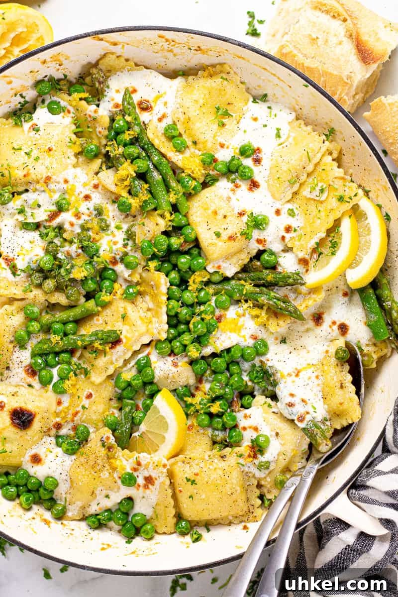 Spring Ravioli with Peas and Asparagus 8 Overhead shot of a large white pan filled with spring ravioli with asparagus peas and cheese