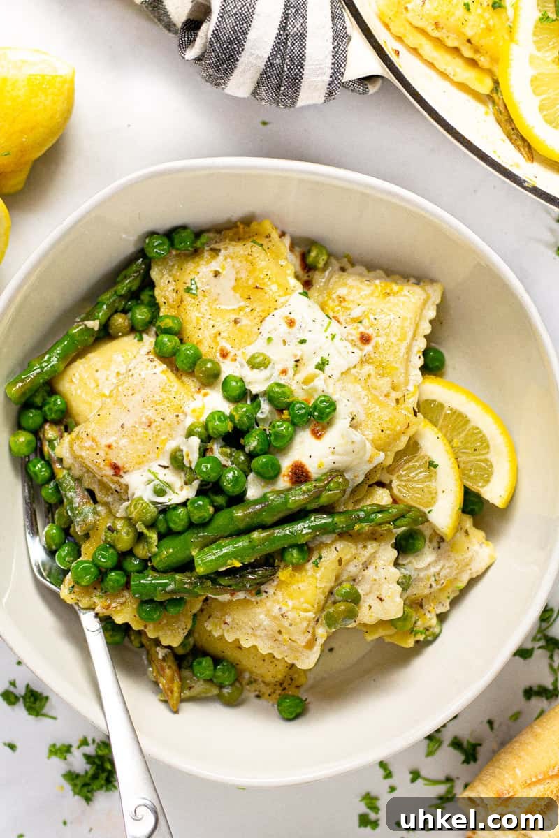 Spring Ravioli with Peas and Asparagus 9 Overhead shot of a large white bowl filled with spring ravioli with asparagus peas and cheese