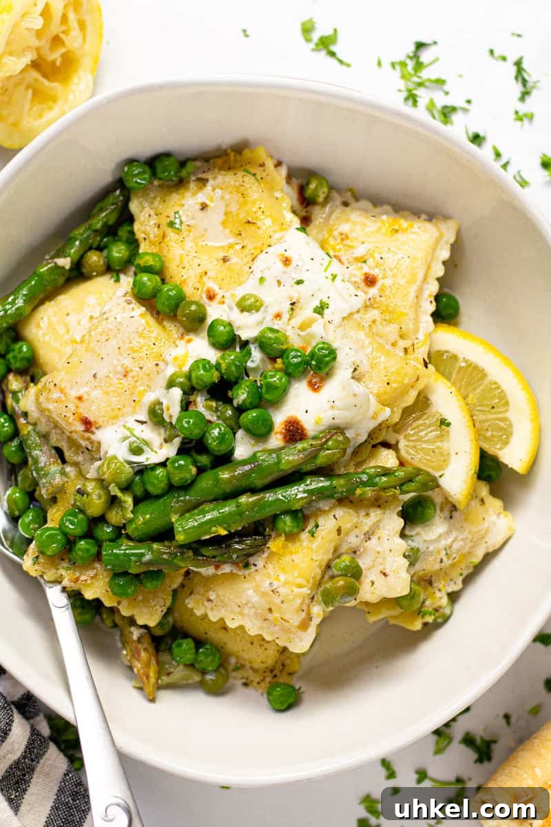 Spring Ravioli with Peas and Asparagus 3 Overhead shot of a large white bowl filled with spring ravioli with asparagus peas and cheese