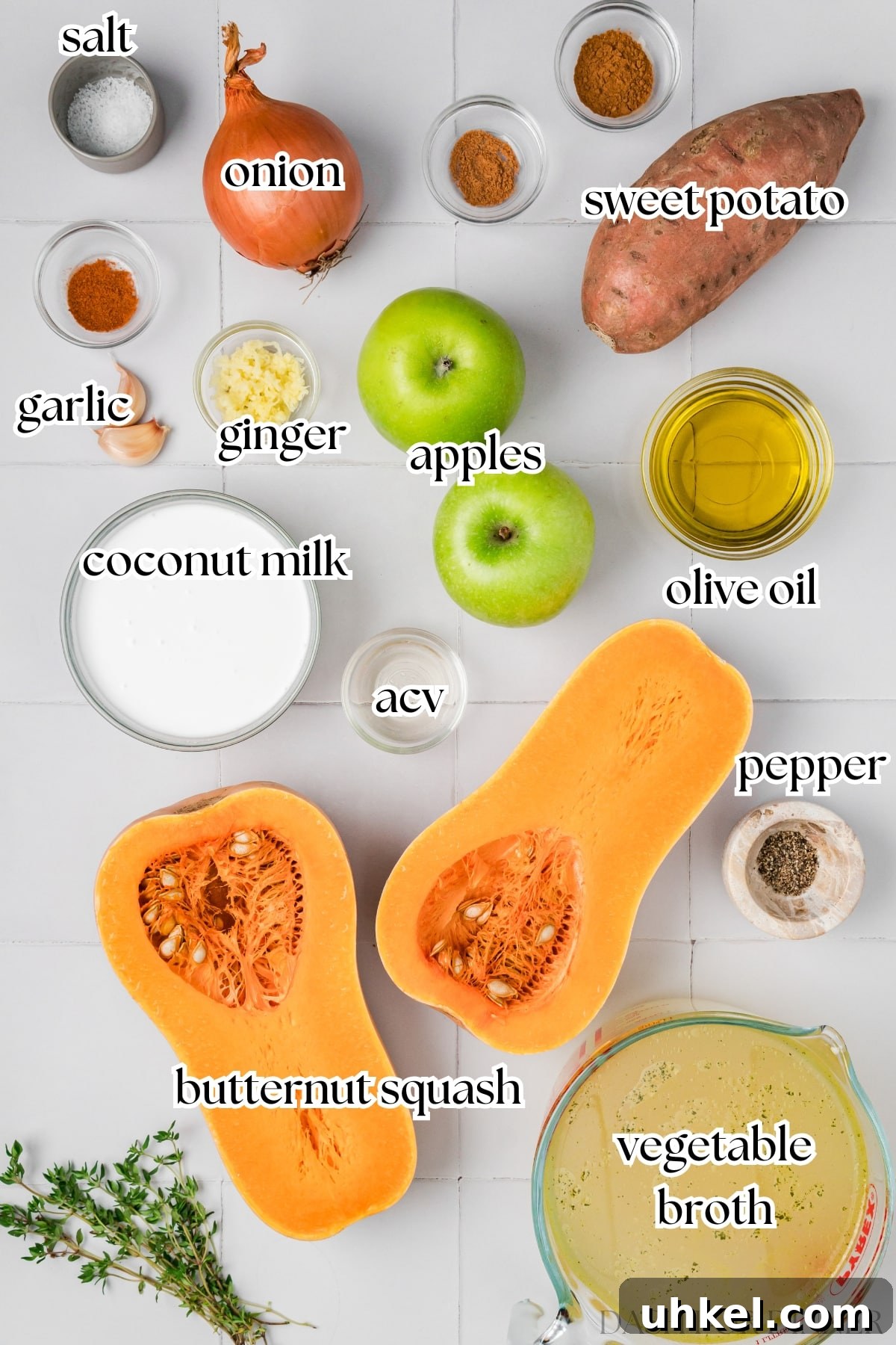 Roasted Butternut Squash and Apple Soup 3 The ingredients needed to make butternut squash and apple soup, including broth, onios, and coconut milk.