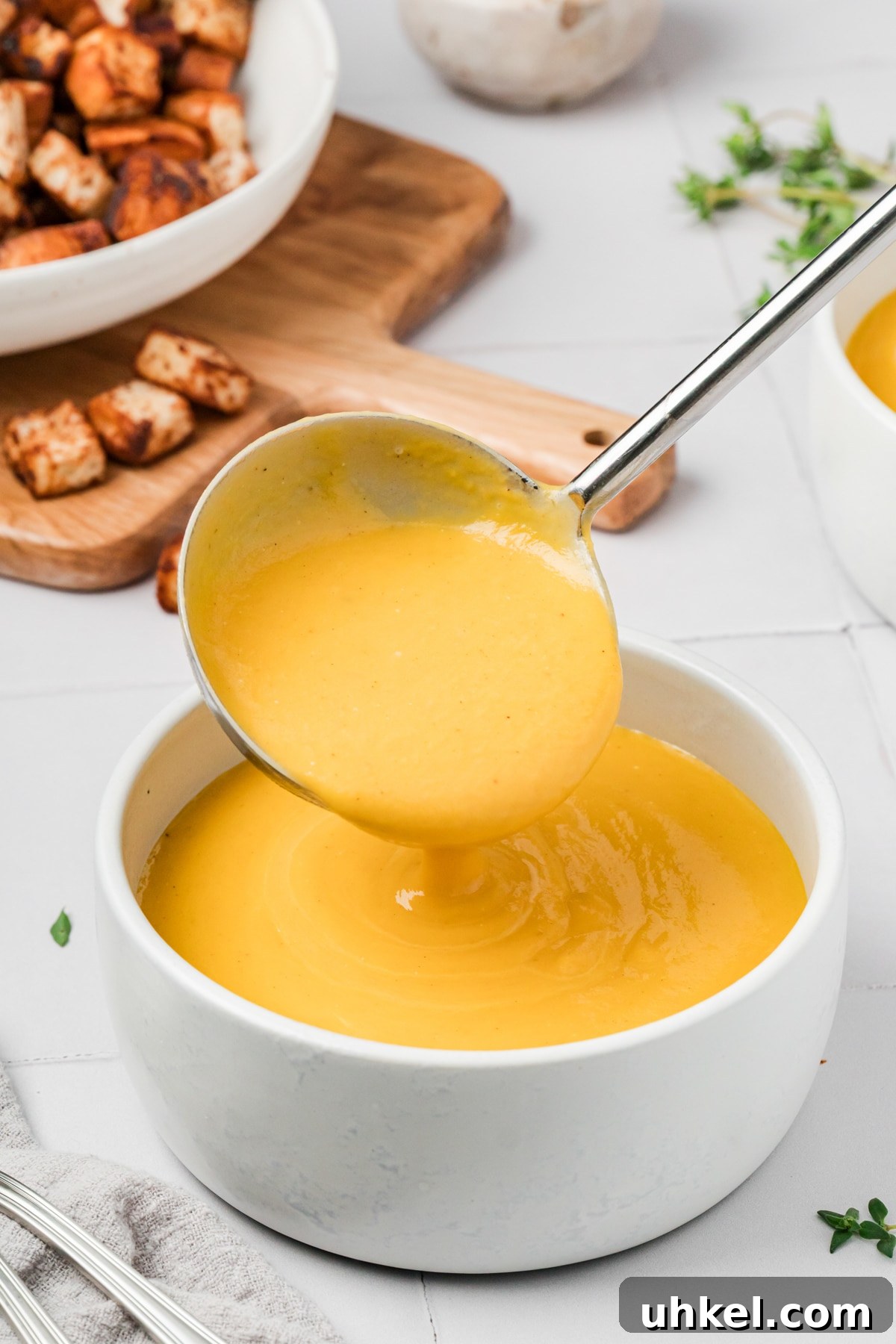Roasted Butternut Squash and Apple Soup 8 Ladling butternut squash soup into a bowl.