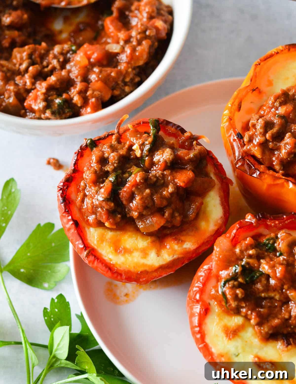 Lasagna Stuffed Bell Peppers with Savory Italian Filling 10 lasagna bell peppers with meat sauce on top.