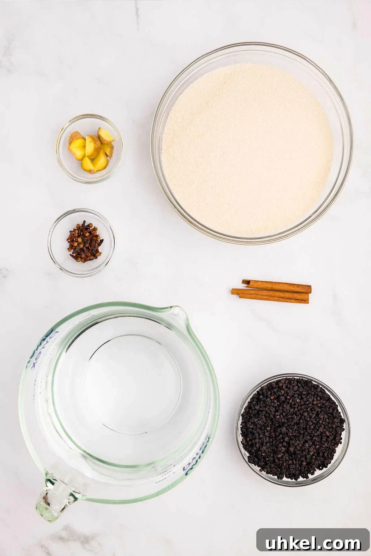 Spiced Elderberry Syrup: Step-by-Step Canning Instructions 3 ingredients measured out in bowls on counter.