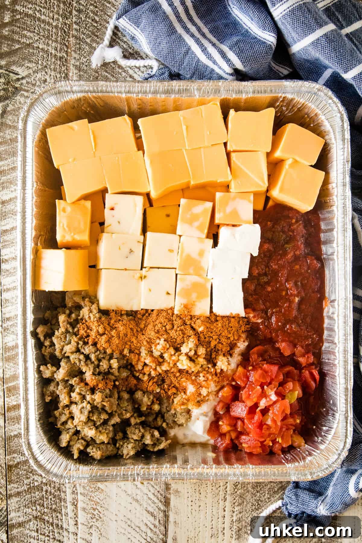 Smoked Queso Dip Recipe with Roasted Peppers and Chipotle 5 Disposable aluminum pan with Smoked Queso Dip ingredients in it before making.