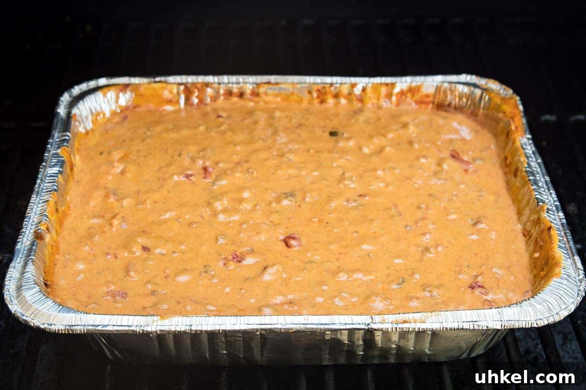 Smoked Queso Dip Recipe with Roasted Peppers and Chipotle 7 Pan of Smoked Queso Dip on smoker